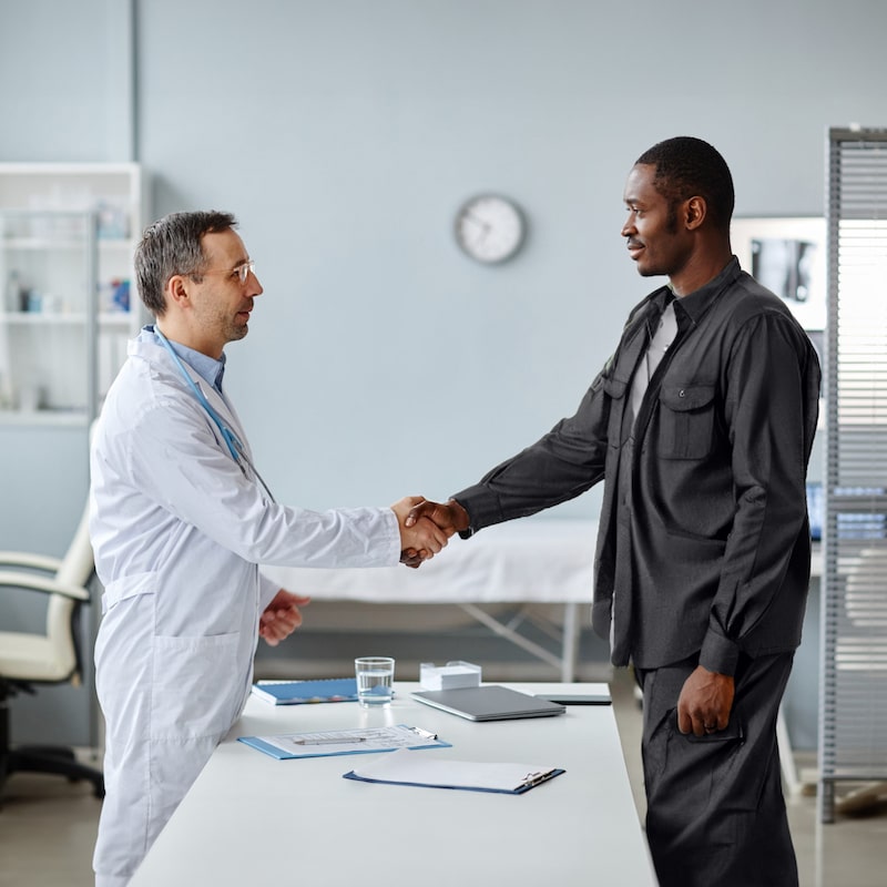 happily shaking hands / doing business with a director of a health center